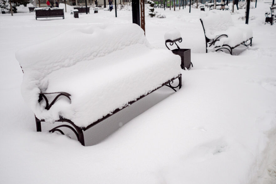snow-covered wooden bench
